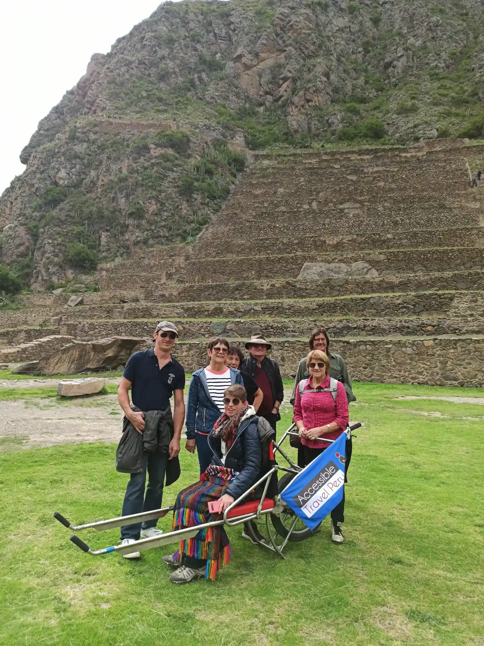 wheelchair traveler carried mountain trail Peru accessible tour Sacred Valley hillside